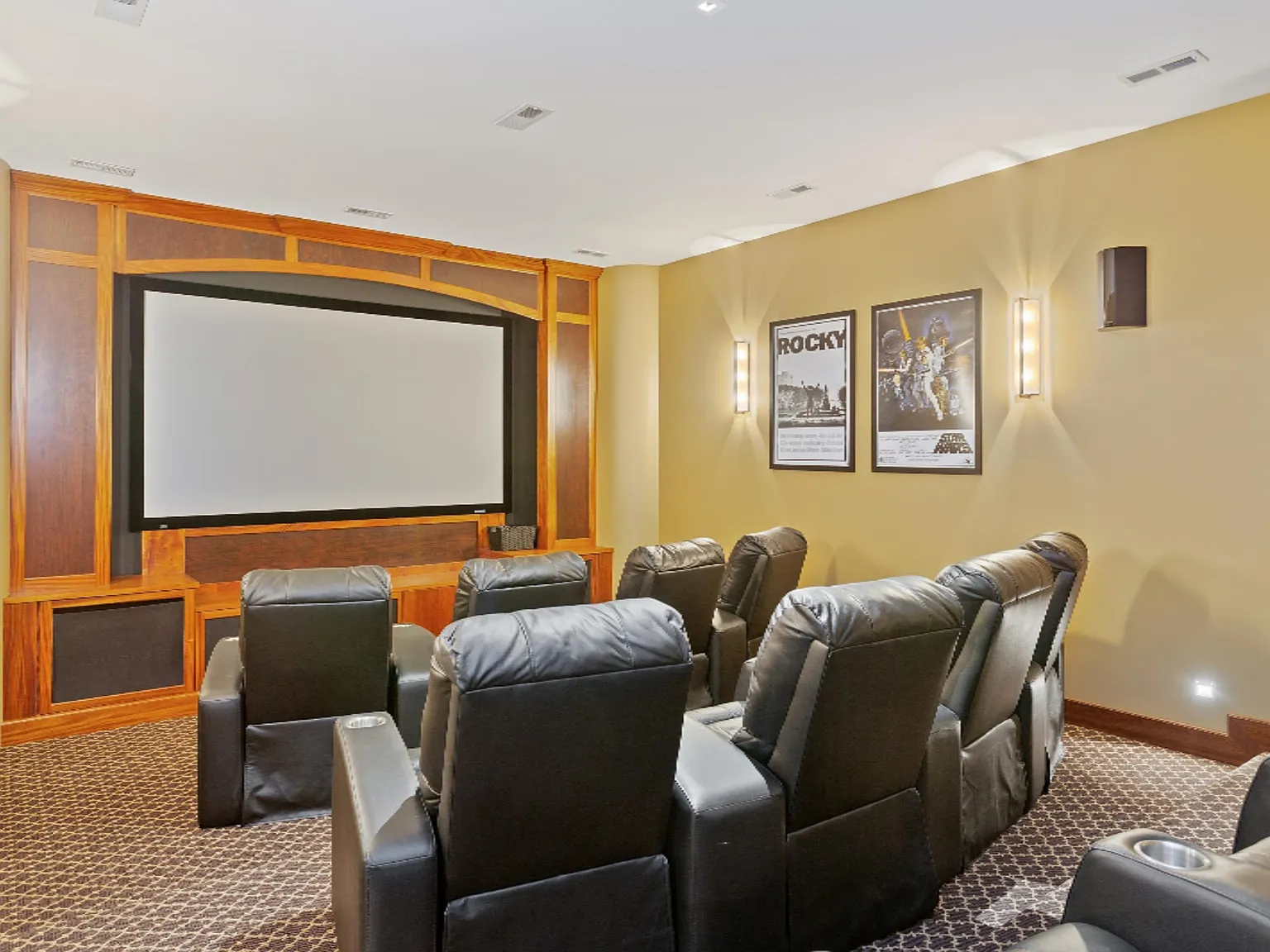 custom theater room with built-ins and wall paneling by BradleyBuilt