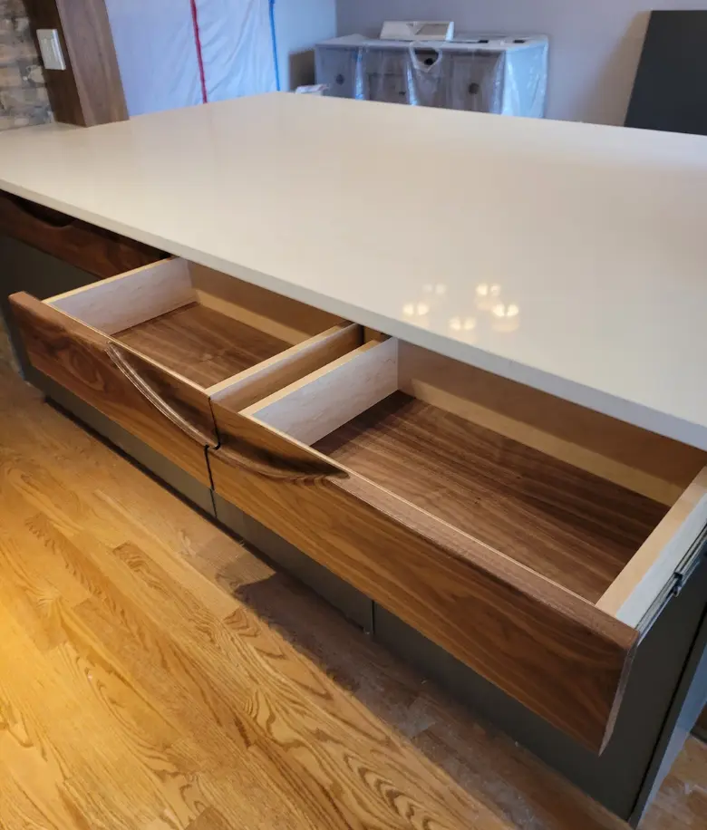 Handless cabinet drawers in walnut