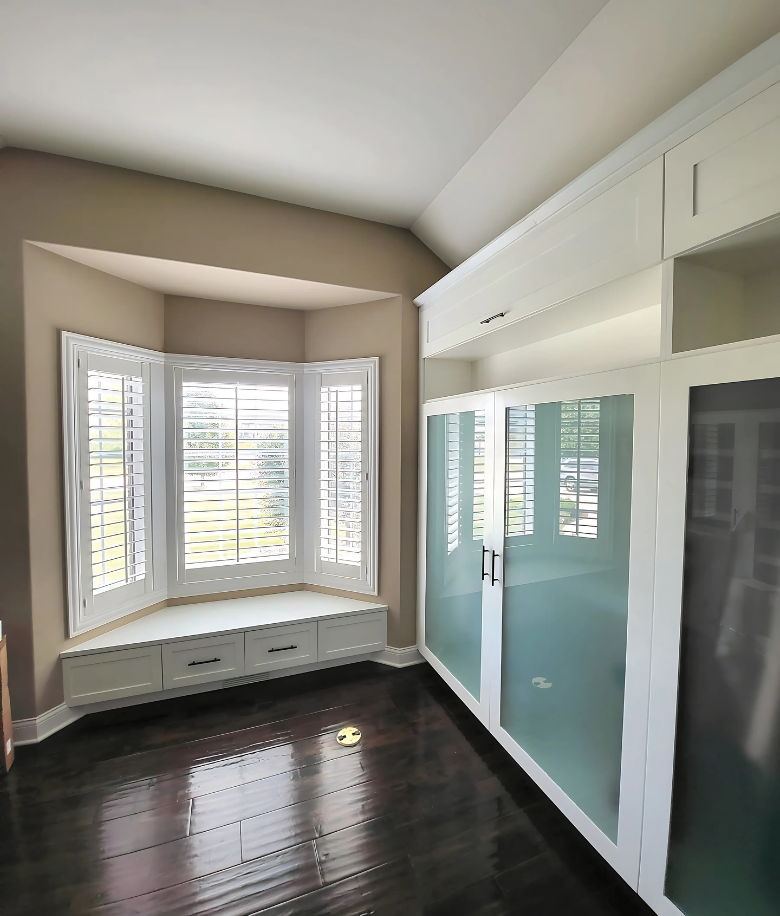 Custom walk-in closet and built-in window bench by BradleyBuilt