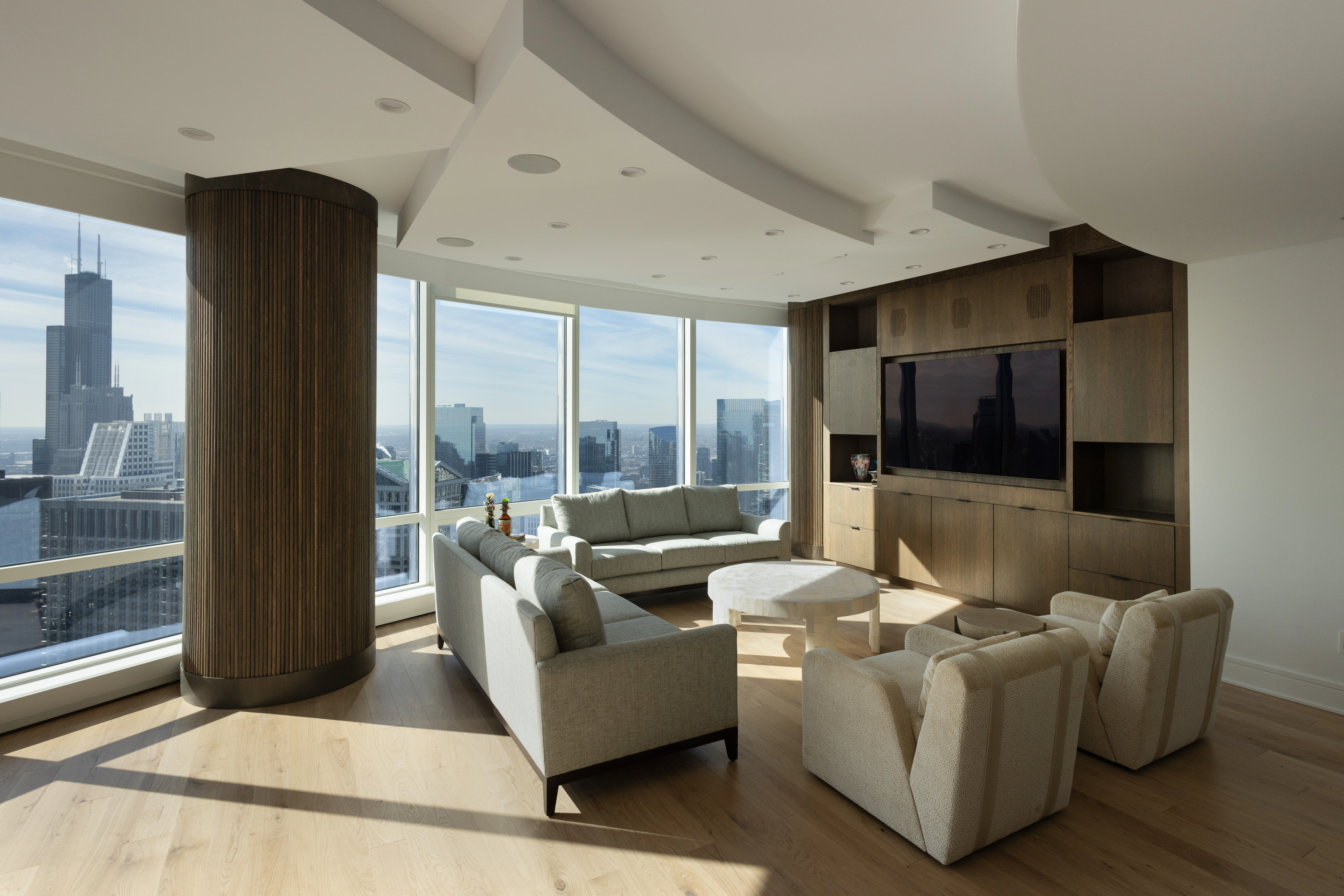 River North condo remodel with custom built-ins and white kitchen cabinets by BradleyBuilt